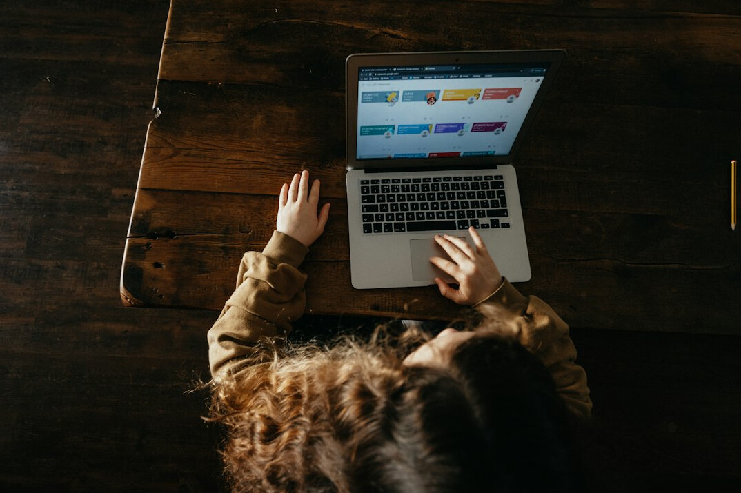 person coding on laptop at home