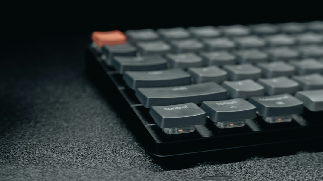 Close-up of hands typing on a mechanical keyboard